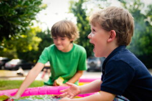 a child with a speech impediment plays with his brother