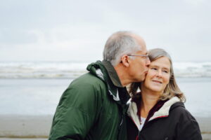 a husband lovingly supports his wife with aphasia
