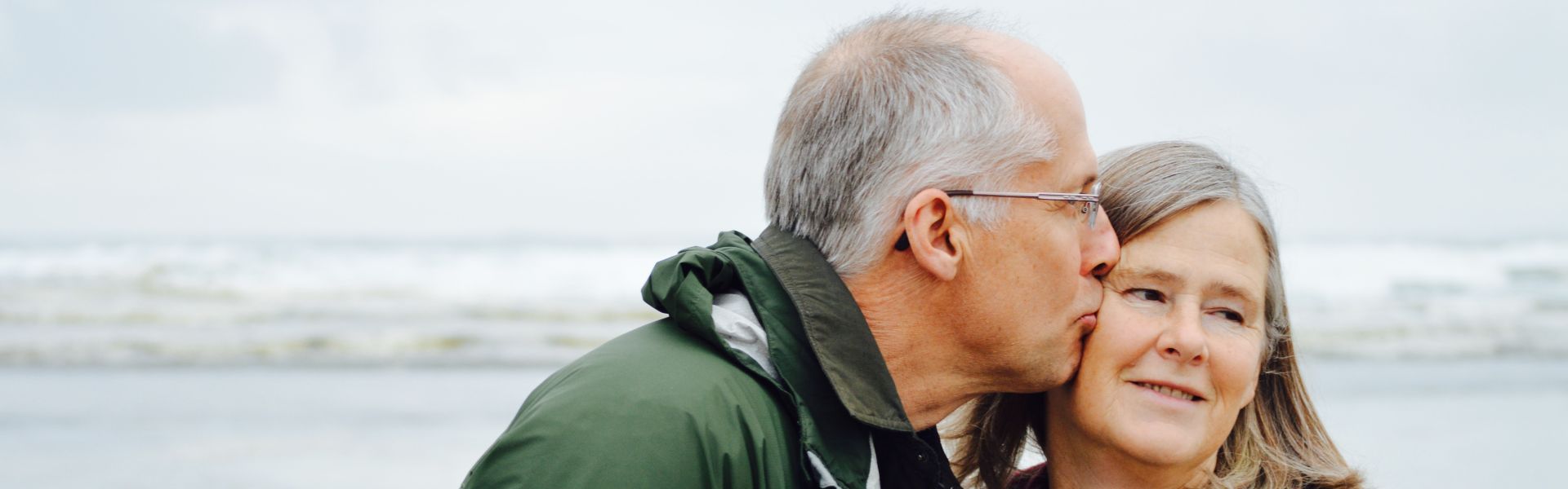 a husband lovingly supports his wife with aphasia
