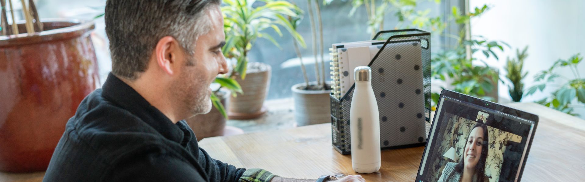 a man participates in online speech therapy from home