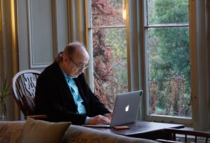 senior adult man participates in an online speech therapy session